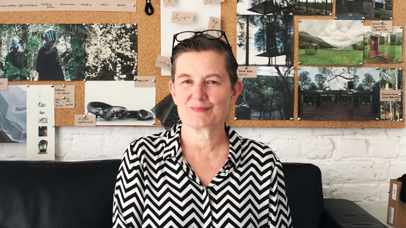 Artist Ju Row Farr in the residents studio, Marina's cork board with research photos is behind her.